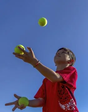 Boy tries juggling. Stock Photos