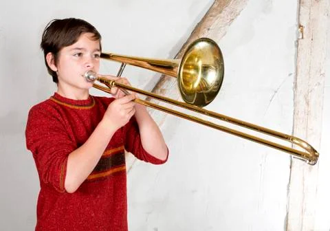 Boy with a trombone Stock Photos