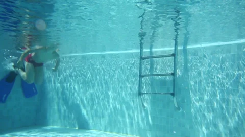 Boy in trunks swimming in the blue pool with flippers 動画素材 34414667