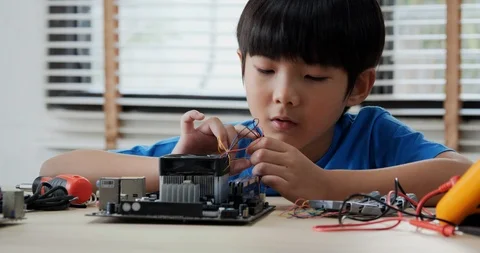 Boy try to fixing computer board in school science club. Stock Footage 108621053