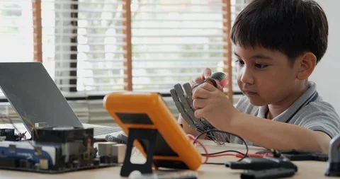 Boy try to fixing computer board in school science club. Stock Footage 108765551