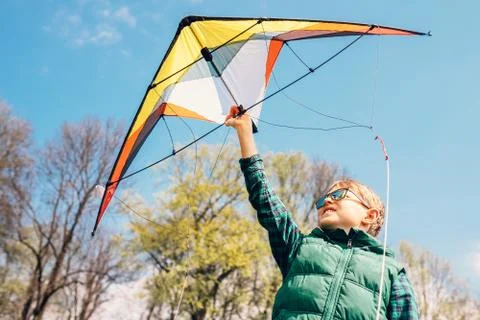 Boy try to start kite in the sky Stock Photos