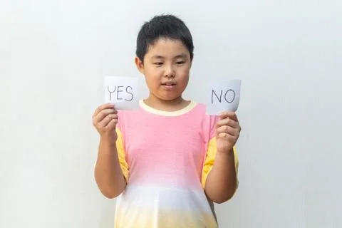 Boy trying to make a decision between Yes or No choice Stock Photos