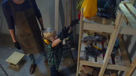 The boy is trying to reach the top shelf, and dad helps him Stock Footage 128183653