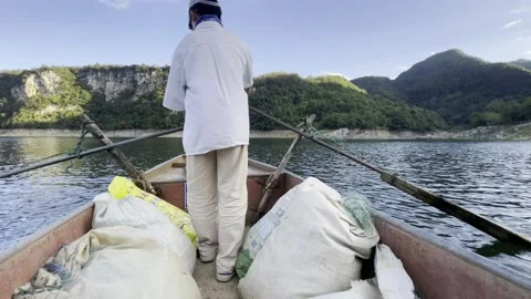 The boy is trying to row the boat away Stock Footage 232116553