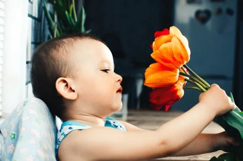 The boy with tulips Stock Photos