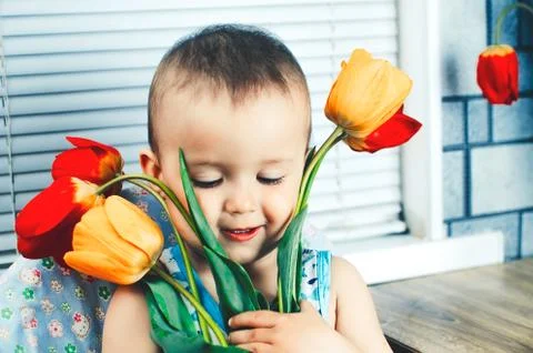 The boy with tulips Stock Photos
