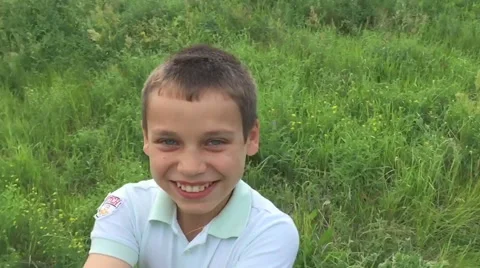 The boy turned and laughing in the summer, slow mo Stock Footage 64970327