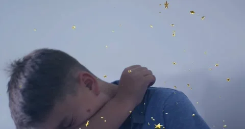 Boy turning head sneezing into elbow on pale couch, rubbing neck, animated gold Stock Footage 330393568