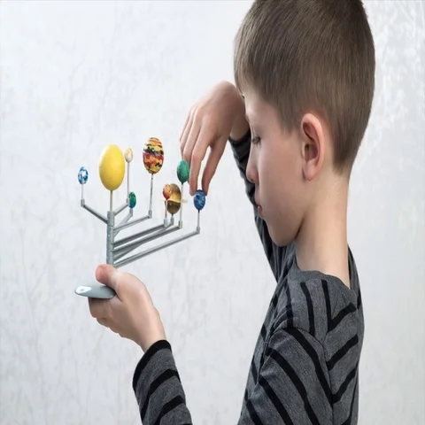 Boy turning the models of planets Stock Footage 69296289