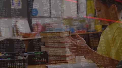 Boy turning pages at classroom desk, activating code overlay and red scan line Stock Footage 312280729