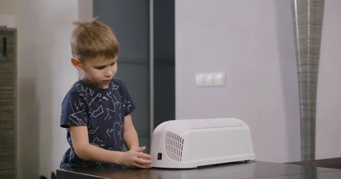 Boy turns on bactericidal irradiator to prevent the spread of the virus and flu Video stock 123982430