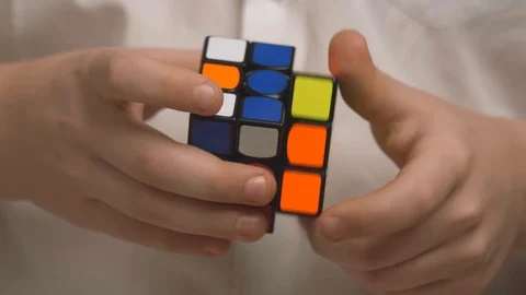 Boy turns the cube Rubik close-up Stock Footage 106333842