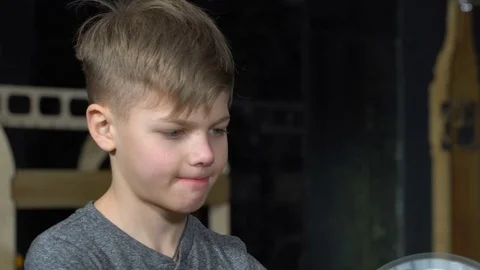 The boy turns the electrostatic machine Stock Footage 72772084