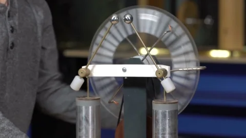 The boy turns the electrostatic machine Stock Footage 72772515