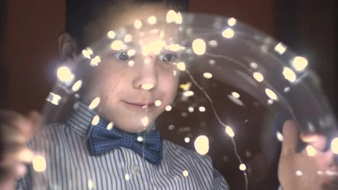 The boy turns a glowing transparent ball in his hands 4K Vidéo 101492902