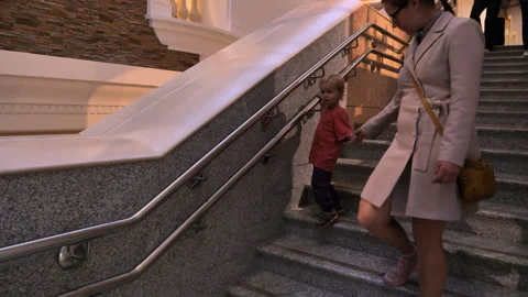 Boy of two and a half years old descends the stairs to the museums Stock Footage 273863924