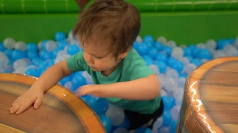 A boy of two or three years old dressed in a turquoise t-shirt  Stock Footage 104028671