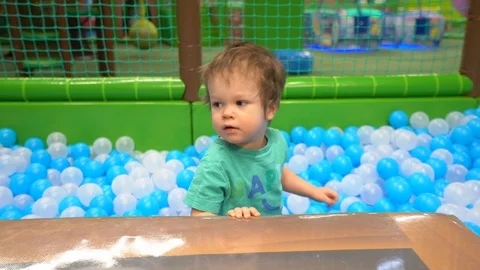 A boy of two or three years dressed in a turquoise t-shirt and dark blue pants  스톡 동영상 104028695