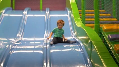 A boy of two or three years dressed in a turquoise t-shirt and dark blue pants  Stock Footage 104028754
