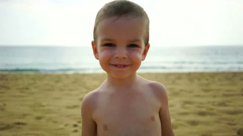 Boy of two years playing on the beach near the ocean. Stock Footage 88531738