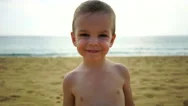 Boy Of Two Years Playing On The Beach Near The Ocean. Stock Footage