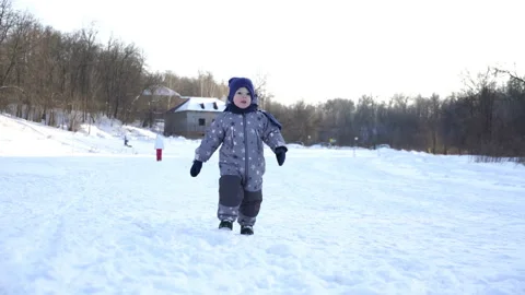 Boy of two years walks in winter. Video stock 85816194