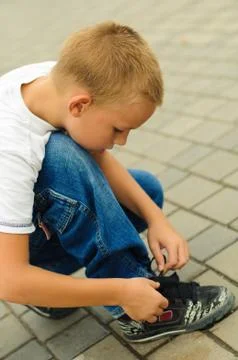 Boy tying the laces Stock Photos