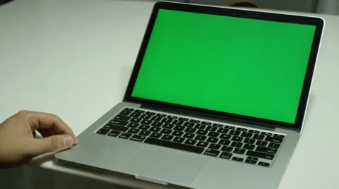 Boy typing on a laptop computer with a green screen Stock Footage 68500953