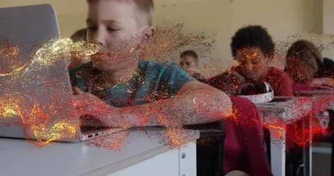 Boy typing on laptop in education class, particle sweeping in from left briefly Stock Footage 331349658