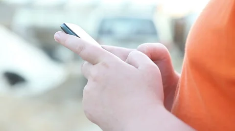 Boy is typing a message on the phone. Hands close-up Stock Footage 63139949