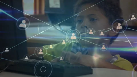 Boy typing at school computer lab, activating animated icons building user Stock Footage 312347857