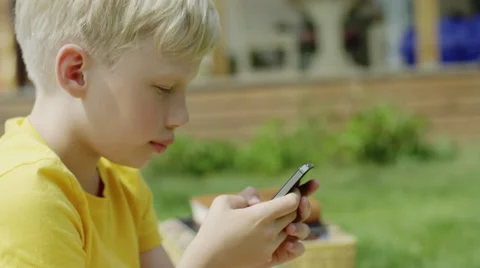 Boy typing on a smartphone Stock Footage 66538994