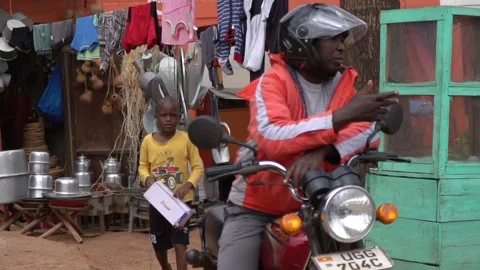 Boy in Uganda looking into the camera 스톡 동영상 306946968