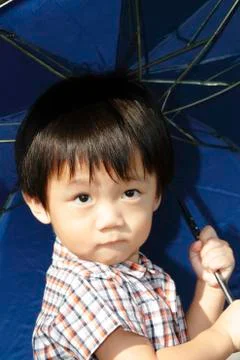 Boy with umbrella Stock Photos