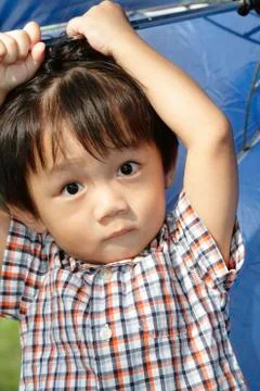 Boy with umbrella Stock Photos