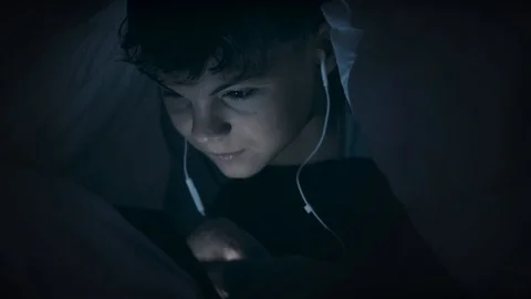 Boy under blanket with tablet Stock Footage 98115836