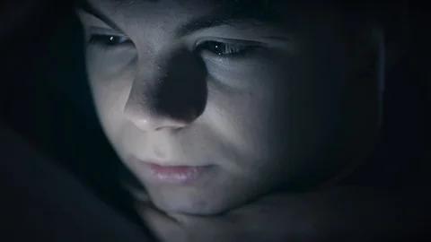 Boy under blanket with tablet Stock Footage 98115851