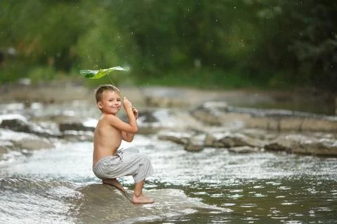 The boy under the burdock. Stock Photos
