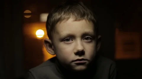 Boy under a flashlight with eyes closed Stock Footage 70319400