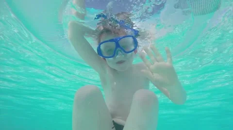 Boy  underwater saying hello Stock Footage 50353105