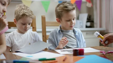 Boy use glue stick to make his application with colored paper Stock Footage 108025464
