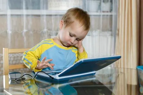 Boy uses a children's game computer Stock Photos