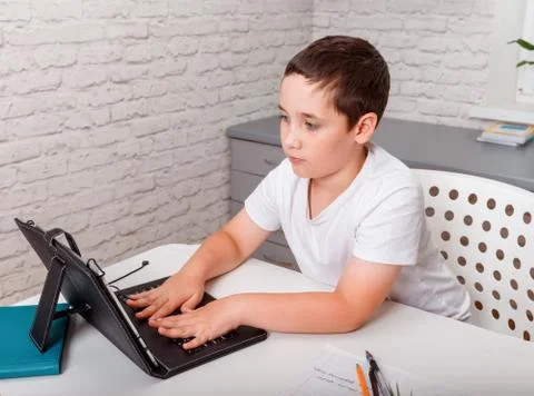 Boy uses digital tablet for video call with his teacher. Homeschooling Foto stock