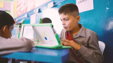 Boy uses a small laptop during a computer class in a Karachi school, Pakistan Stock Footage 329222403