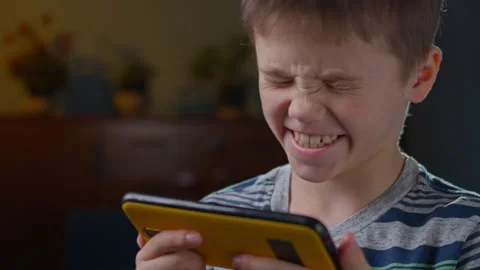 The boy uses a smartphone. Stock Footage 303385023