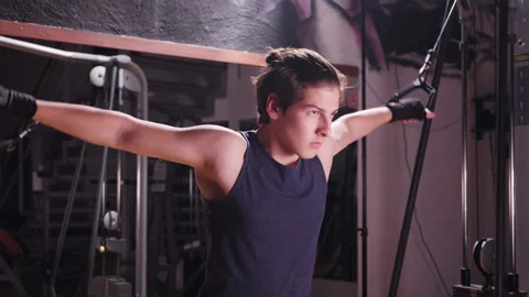 Boy using bodybuilding machine in gym - close up Video stock 157496161