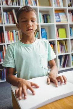 Boy using braille to read 스톡 사진