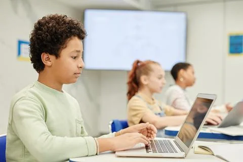 Boy Using Computer in Class Stock Photos
