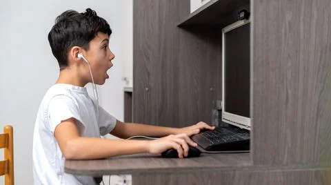 Boy using computer at home Stock Photos